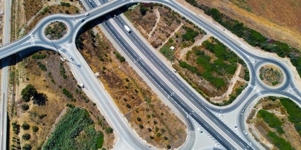 Top-down aerial view showcasing highways and roundabouts intertwined with greenery.